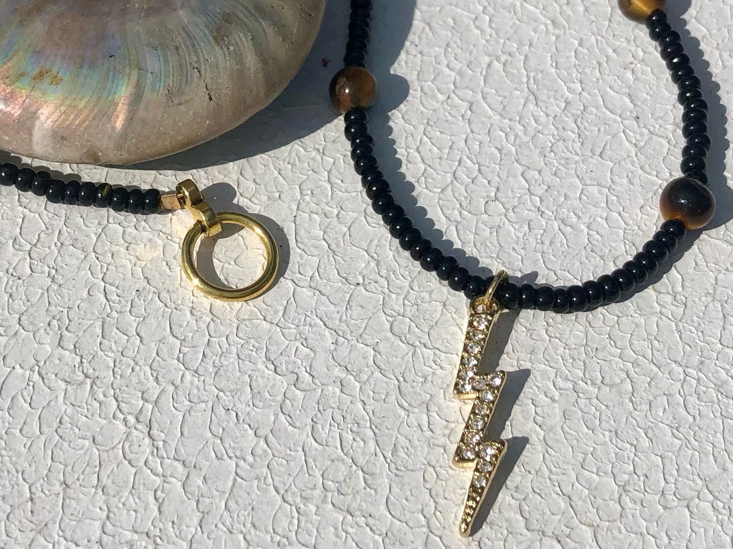 Lightning Bolt w/ Clear Crystals Strung w/ Black Seed Beads & Tiger's Eye