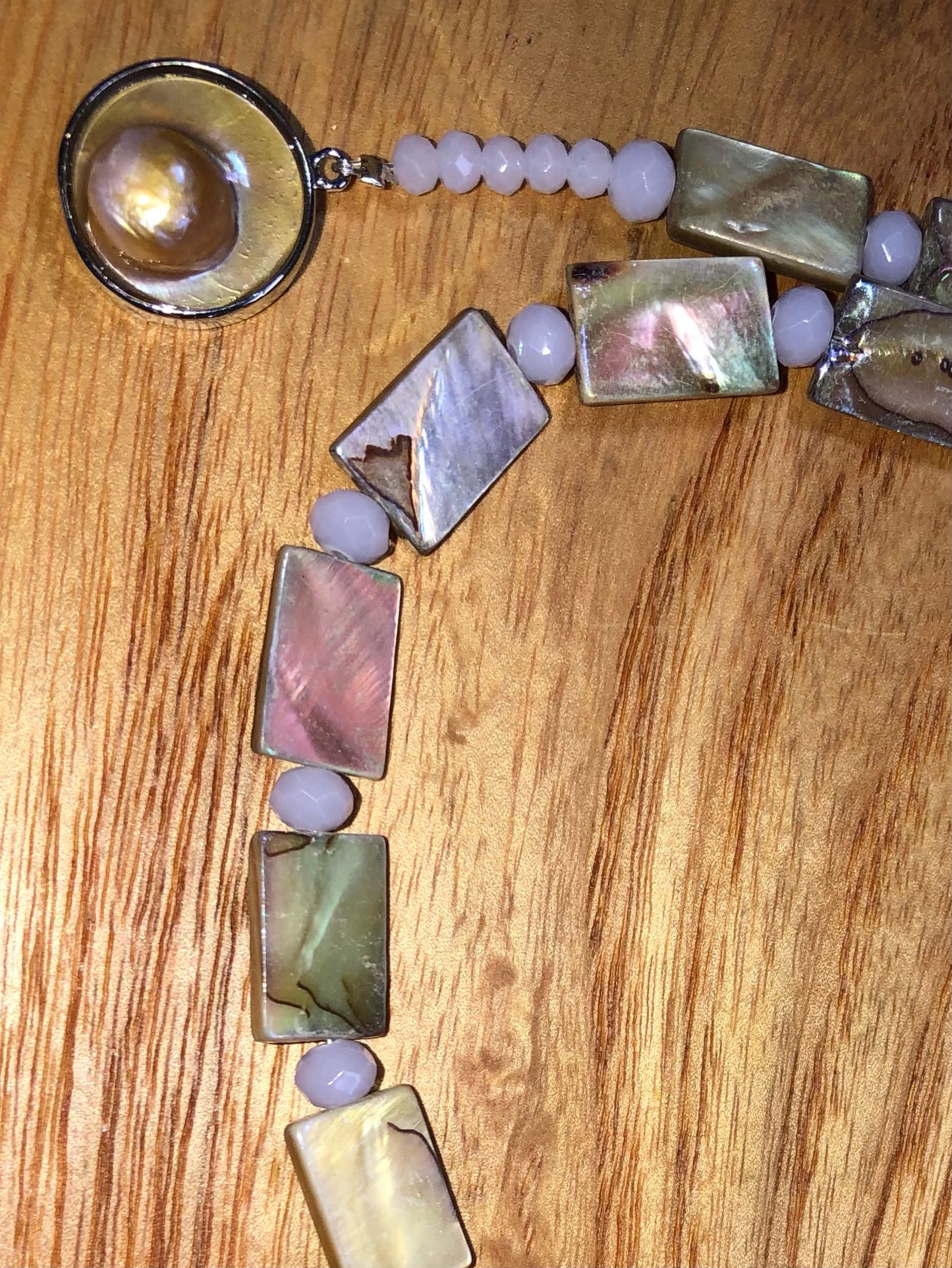 Weather seashell necklace with mother of pearl beads, glass beads, and silver plated pearl clasp.