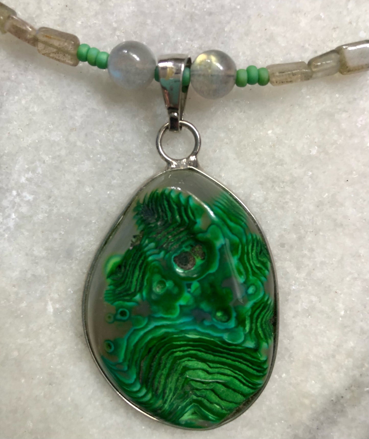 Green moss agate necklace with labradorite beads, green glass seed beads, and silver plated fish clasp.