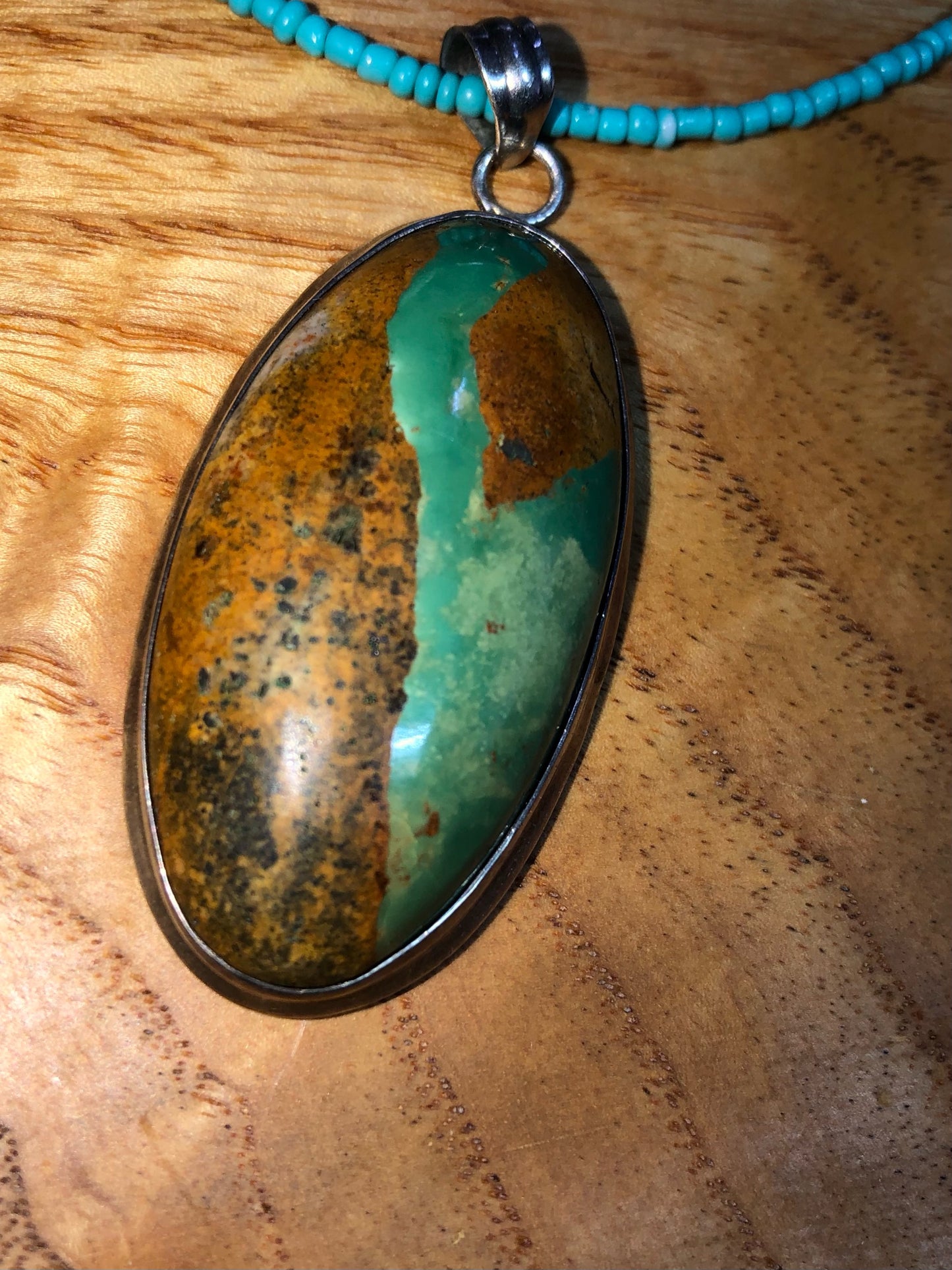 Sterling silver Royston turquoise pendant, strung on a necklace with turquoise glass seed beads, and silver plated lotus beads.