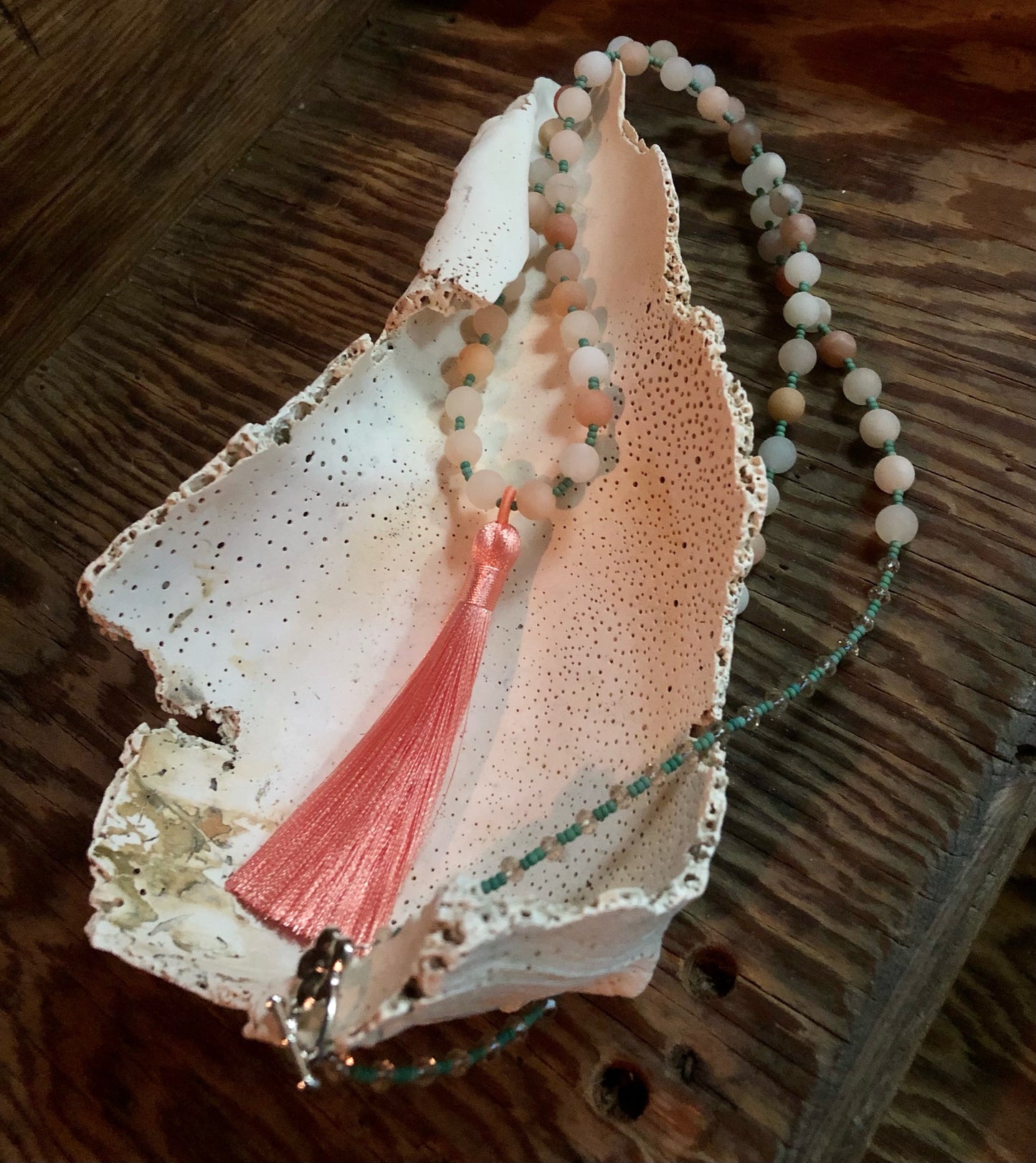 Mala with 54 matte peach aventurine beads, Austrian light peach faceted crystal beads, green glass seed beads, and 3.54" peach tassel.