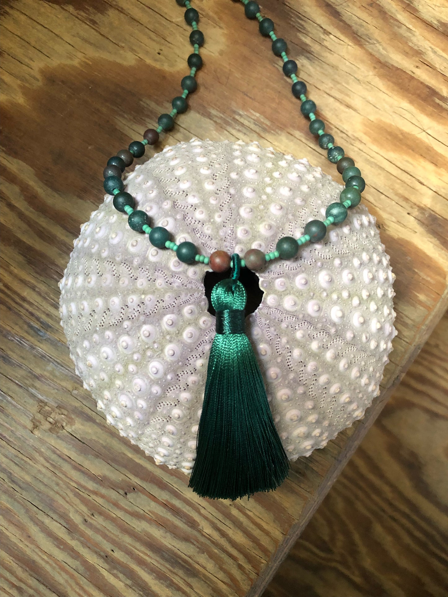 54 bloodstone beaded mala with green glass seed beads, silver plated lotus beads, and 3.54" green tassel.