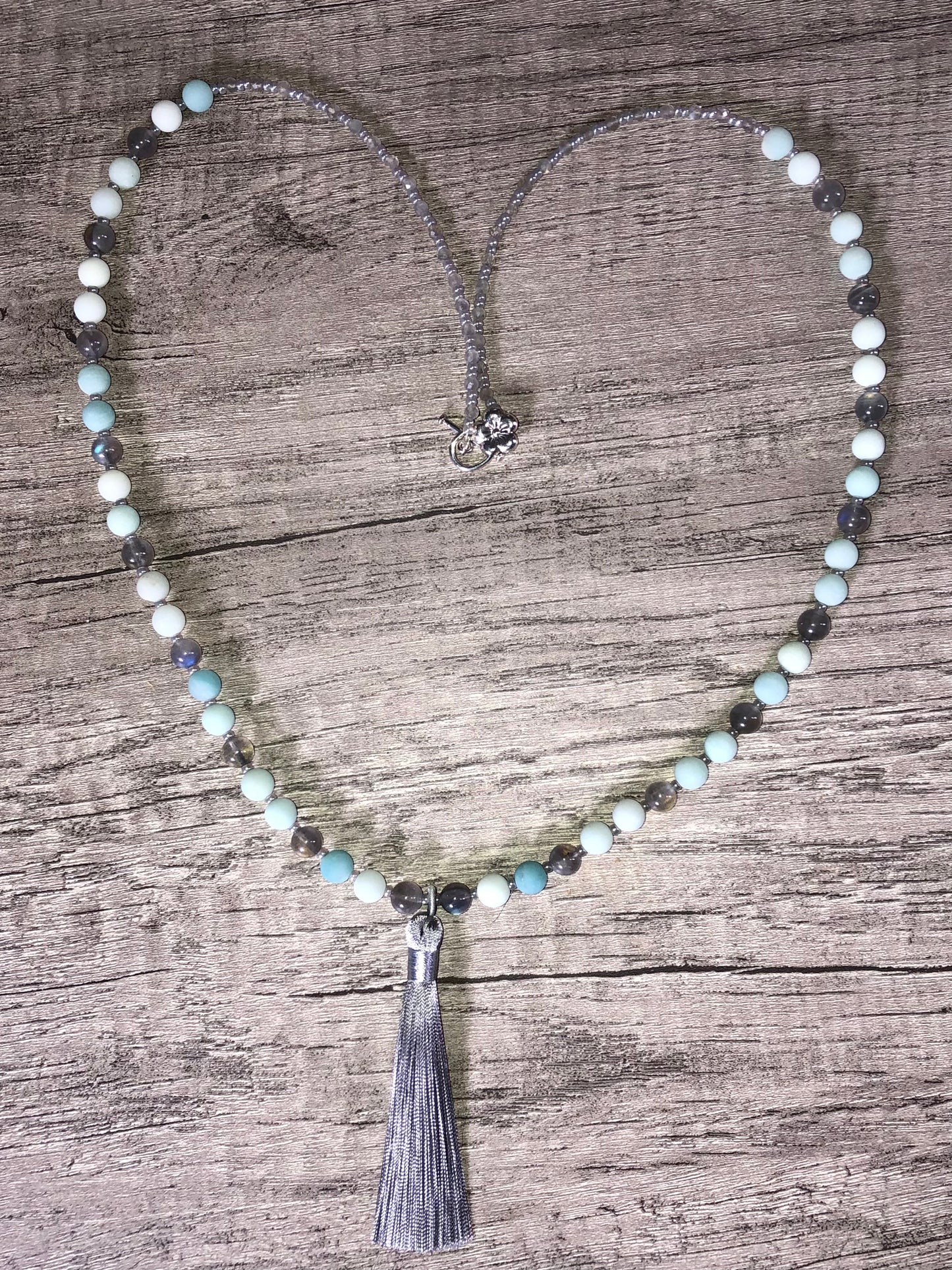 Mala with matte blue aventurine beads, labradorite beads, ceylon glass seed beads, silver plated clasp, and ceylon tassel.