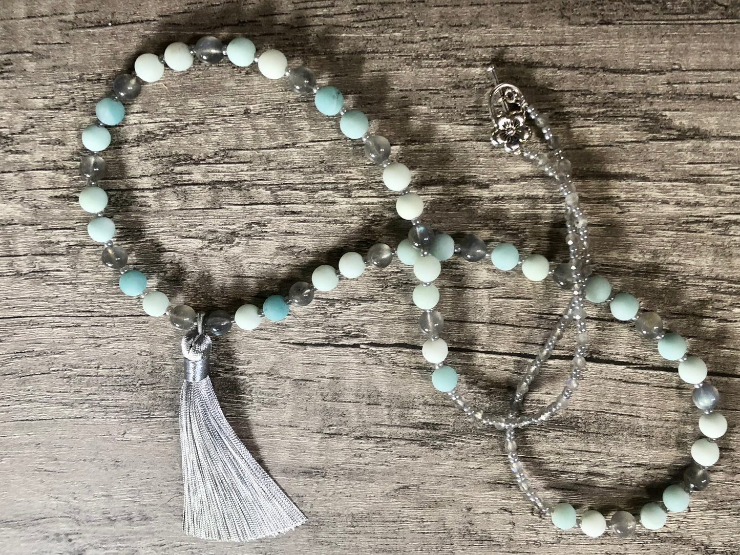 Mala with matte blue aventurine beads, labradorite beads, ceylon glass seed beads, silver plated clasp, and ceylon tassel.