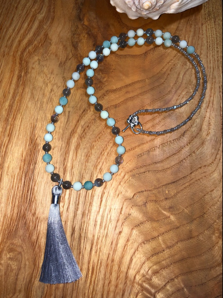 Mala with matte blue aventurine beads, labradorite beads, ceylon glass seed beads, silver plated clasp, and ceylon tassel.