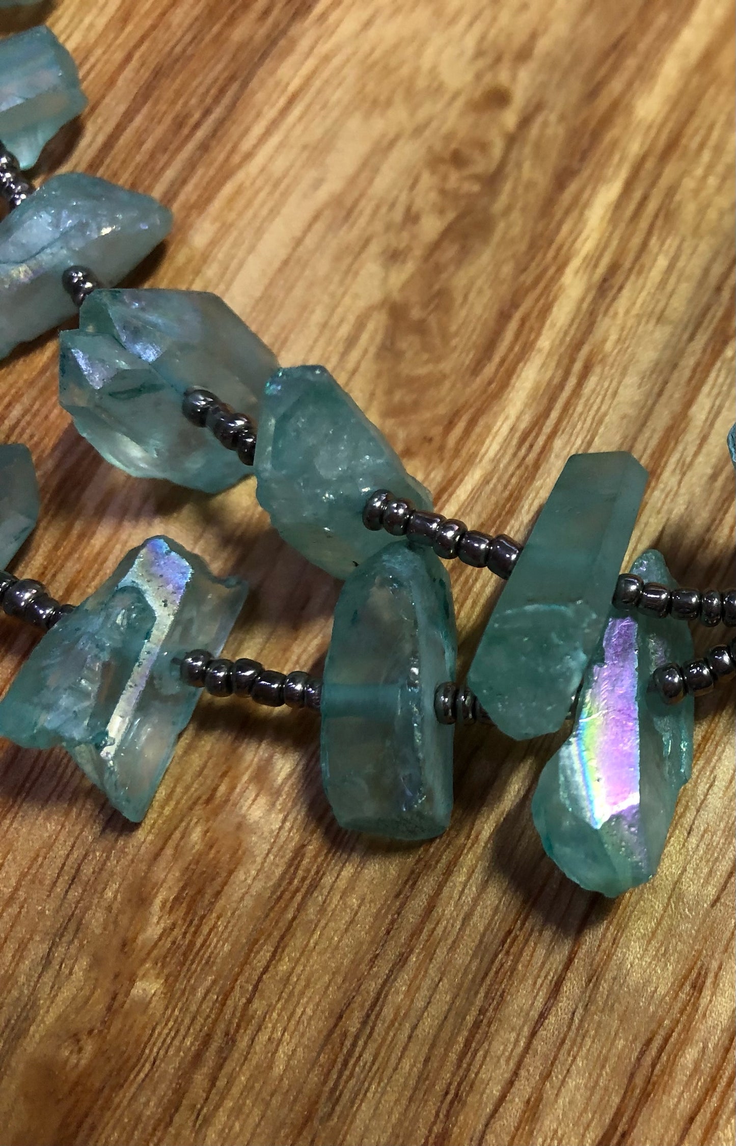 Aqua aura quartz points necklace with white coral, glass seed beads, & silver plated pearl clasp.