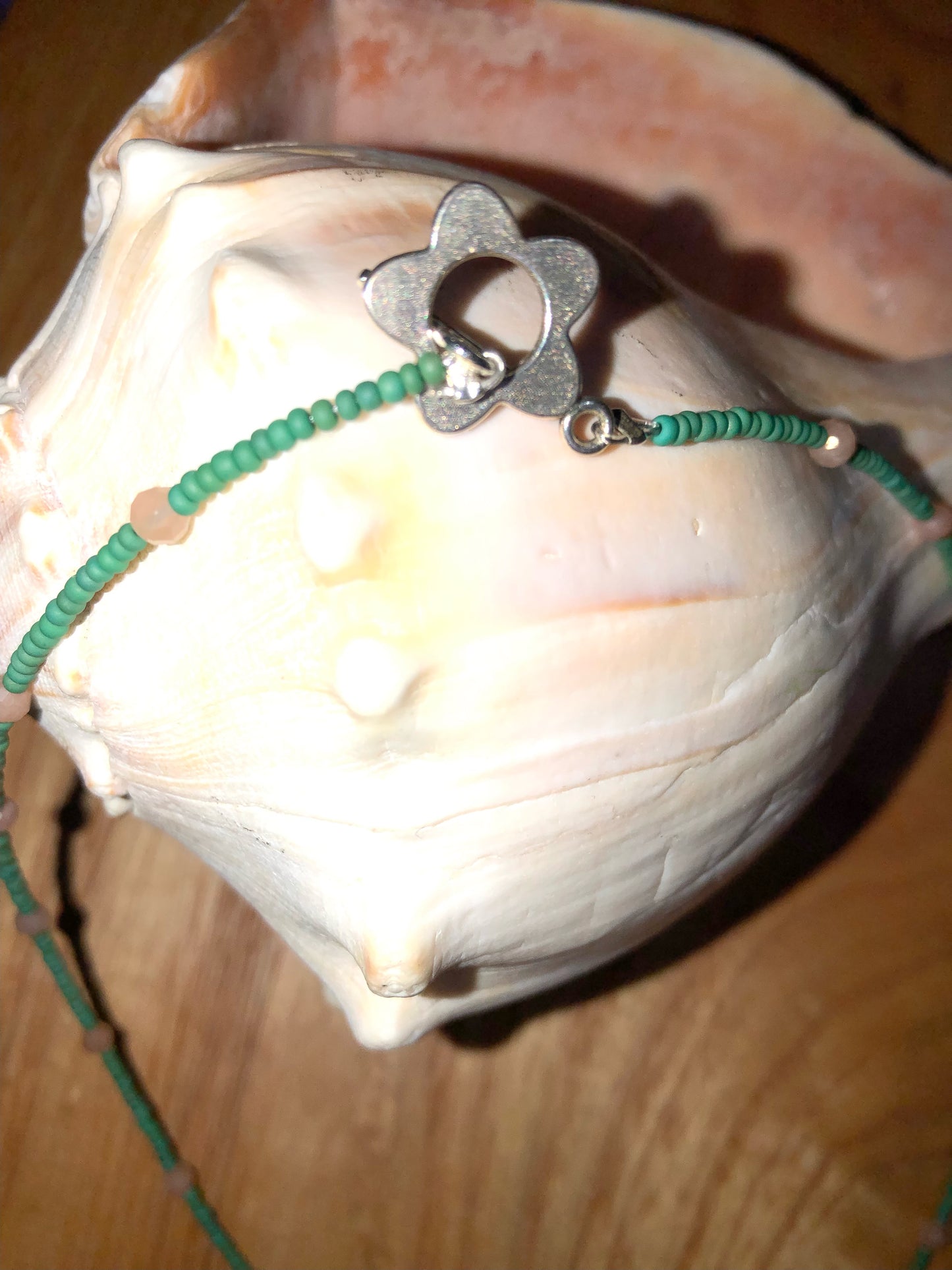 Green aventurine pendant/necklace with peach sunstone beads, green glass seed beads, and 19mm silver plated clear crystal starburst charm.