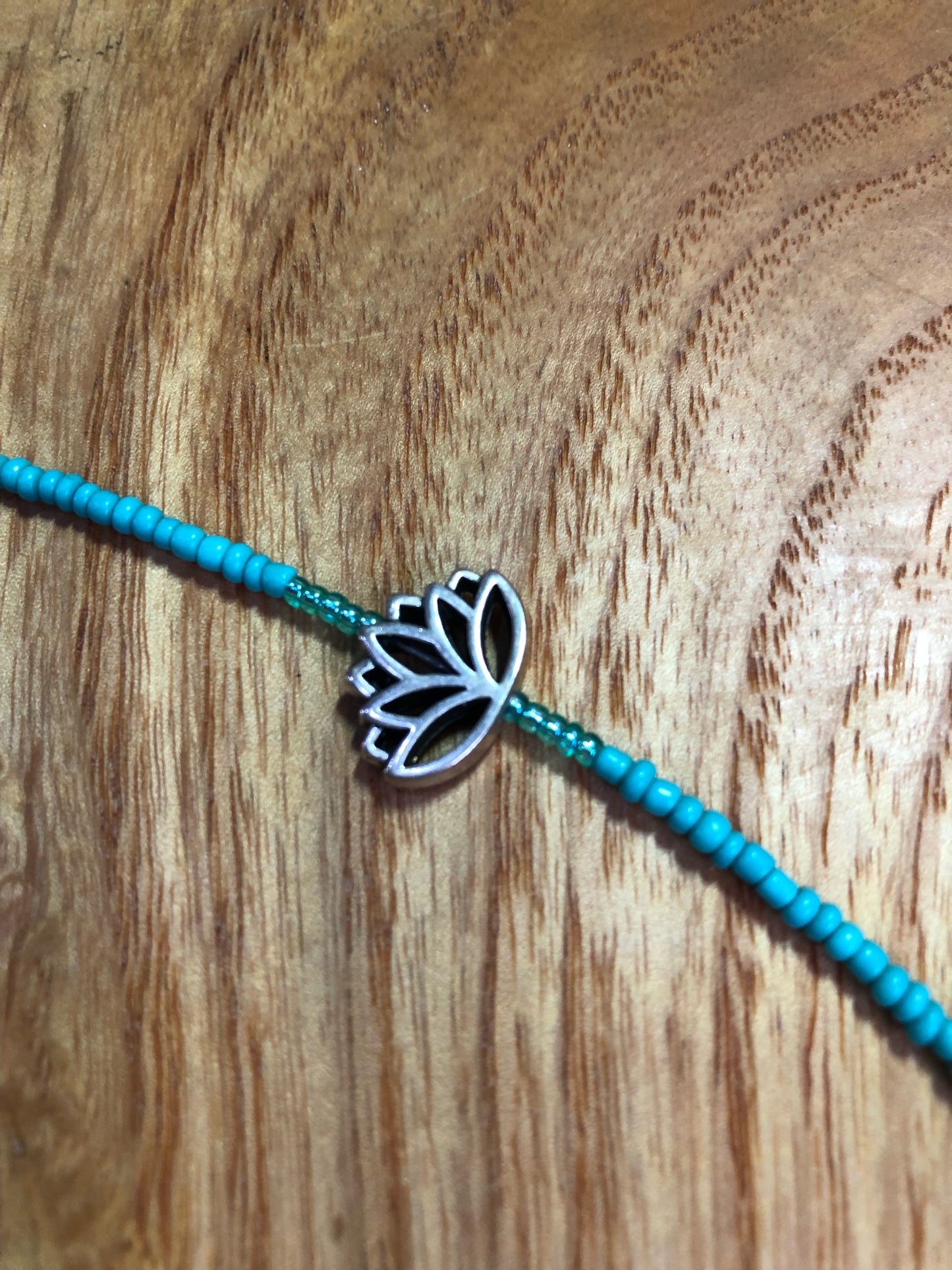 Sterling silver Royston turquoise pendant, strung on a necklace with turquoise glass seed beads, and silver plated lotus beads.