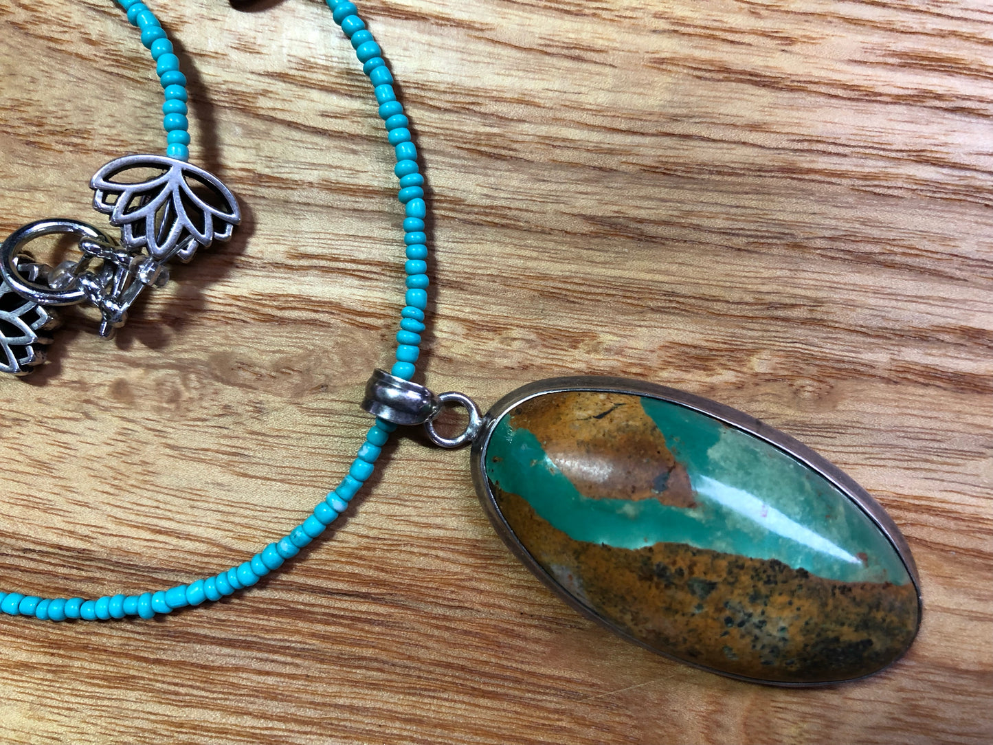 Sterling silver Royston turquoise pendant, strung on a necklace with turquoise glass seed beads, and silver plated lotus beads.