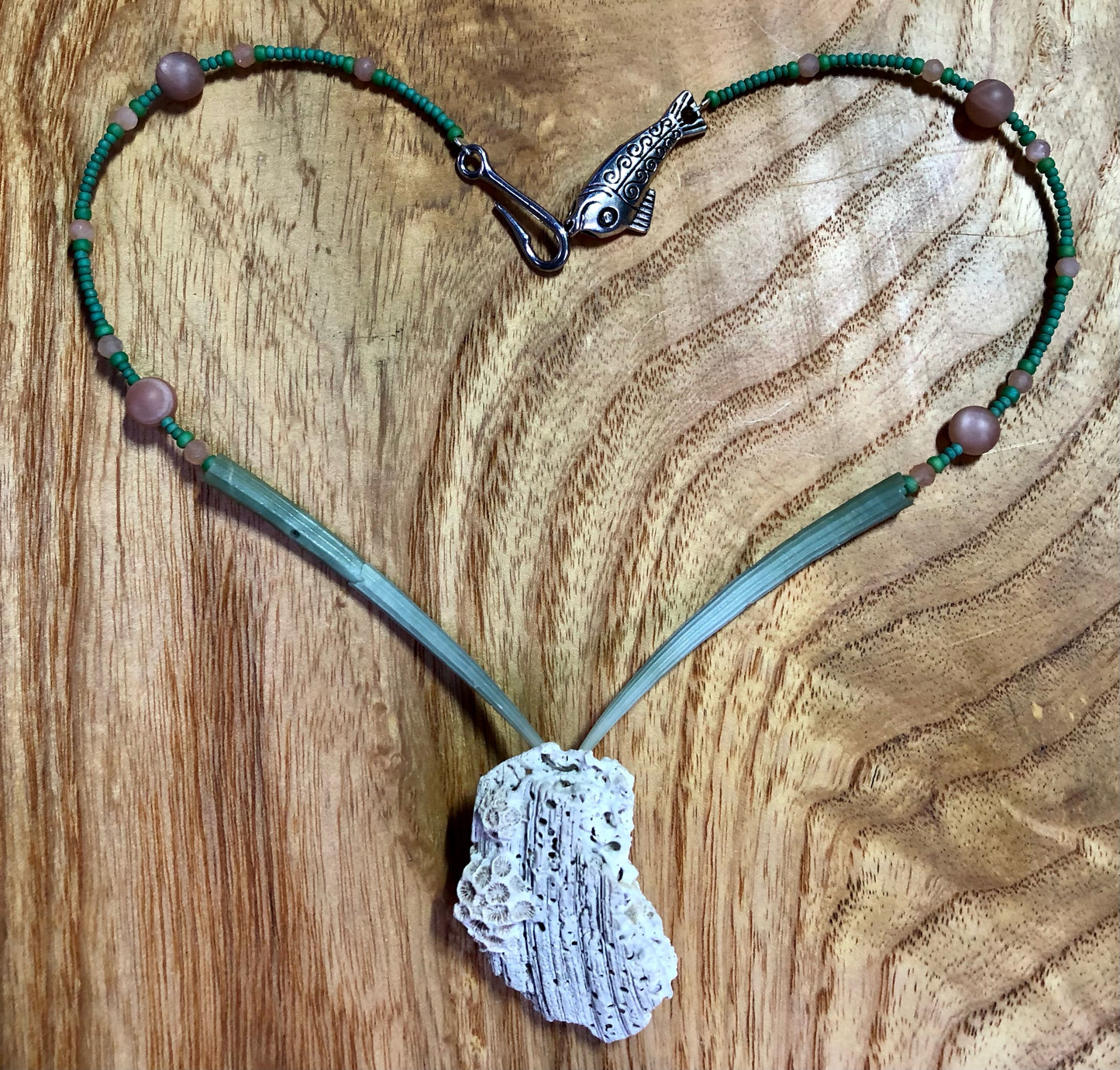 White coral necklace with natural green dentalium tusk shells, peach sunstone beads, and antique silver alloy fish clasp.