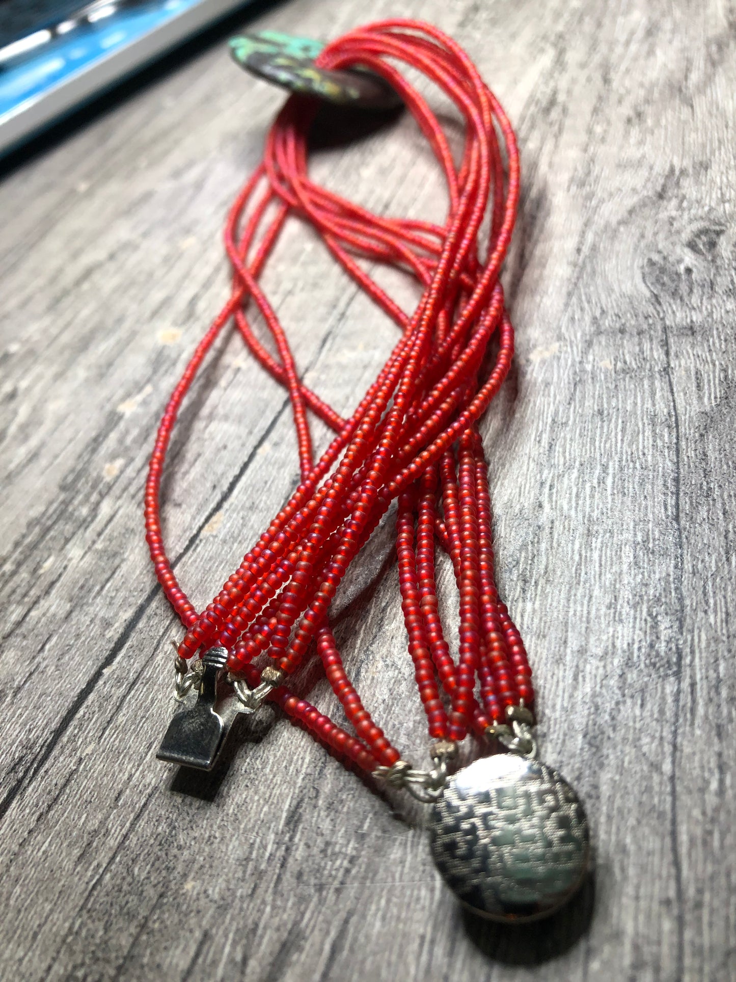 Turquoise Donut Pendant Strung on 8 Strands of Red Glass Seed Beads