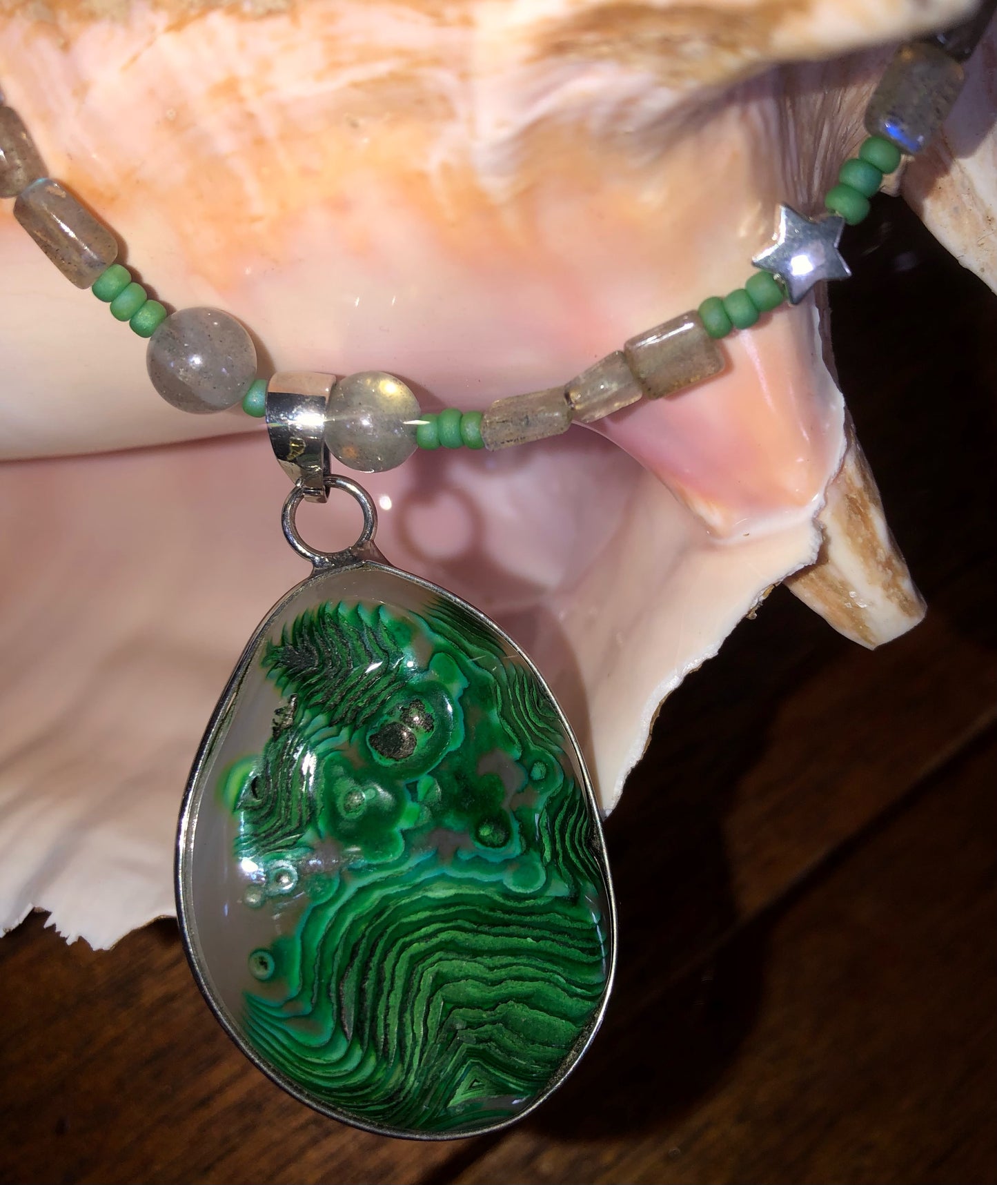 Green moss agate necklace with labradorite beads, green glass seed beads, and silver plated fish clasp.