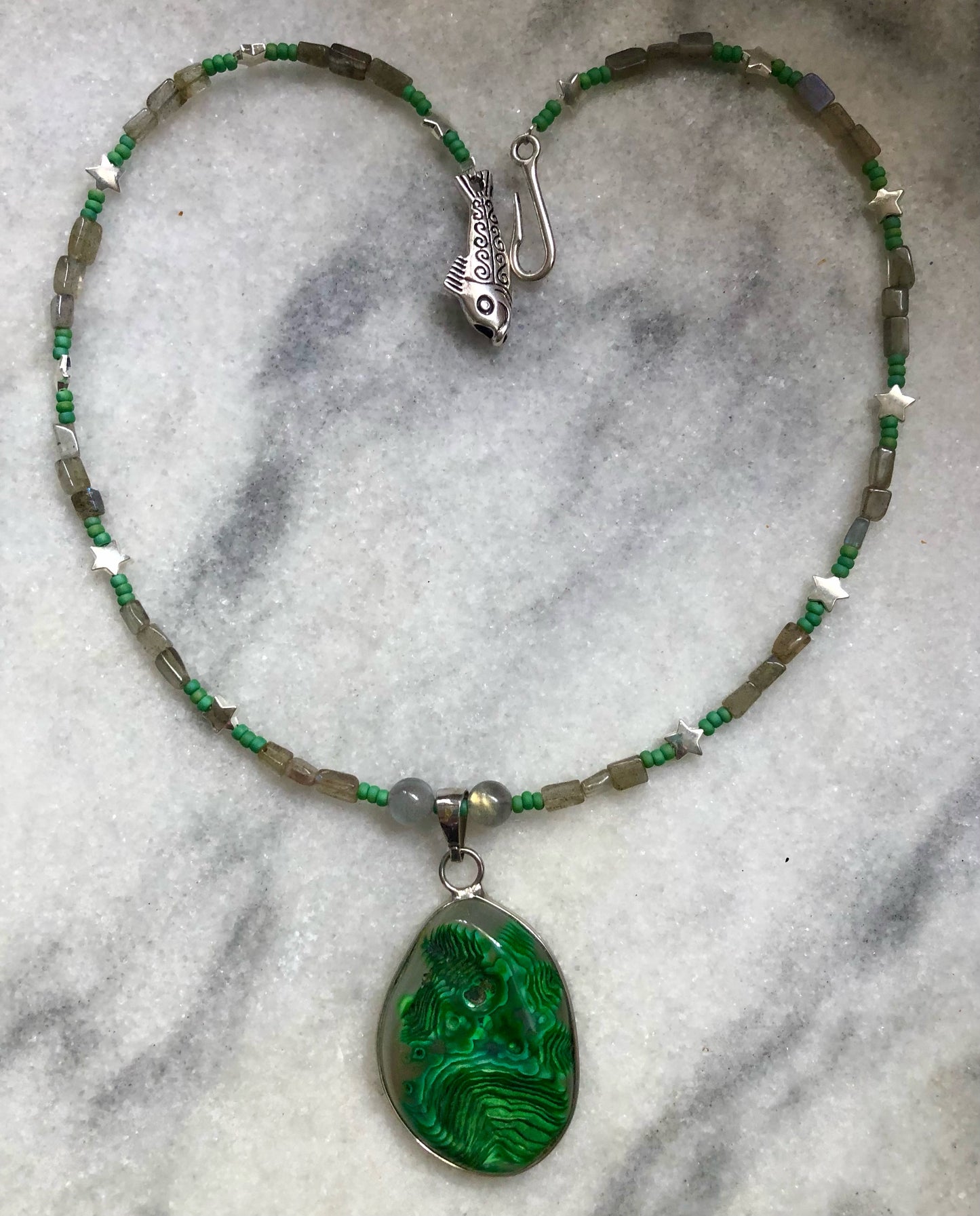 Green moss agate necklace with labradorite beads, green glass seed beads, and silver plated fish clasp.