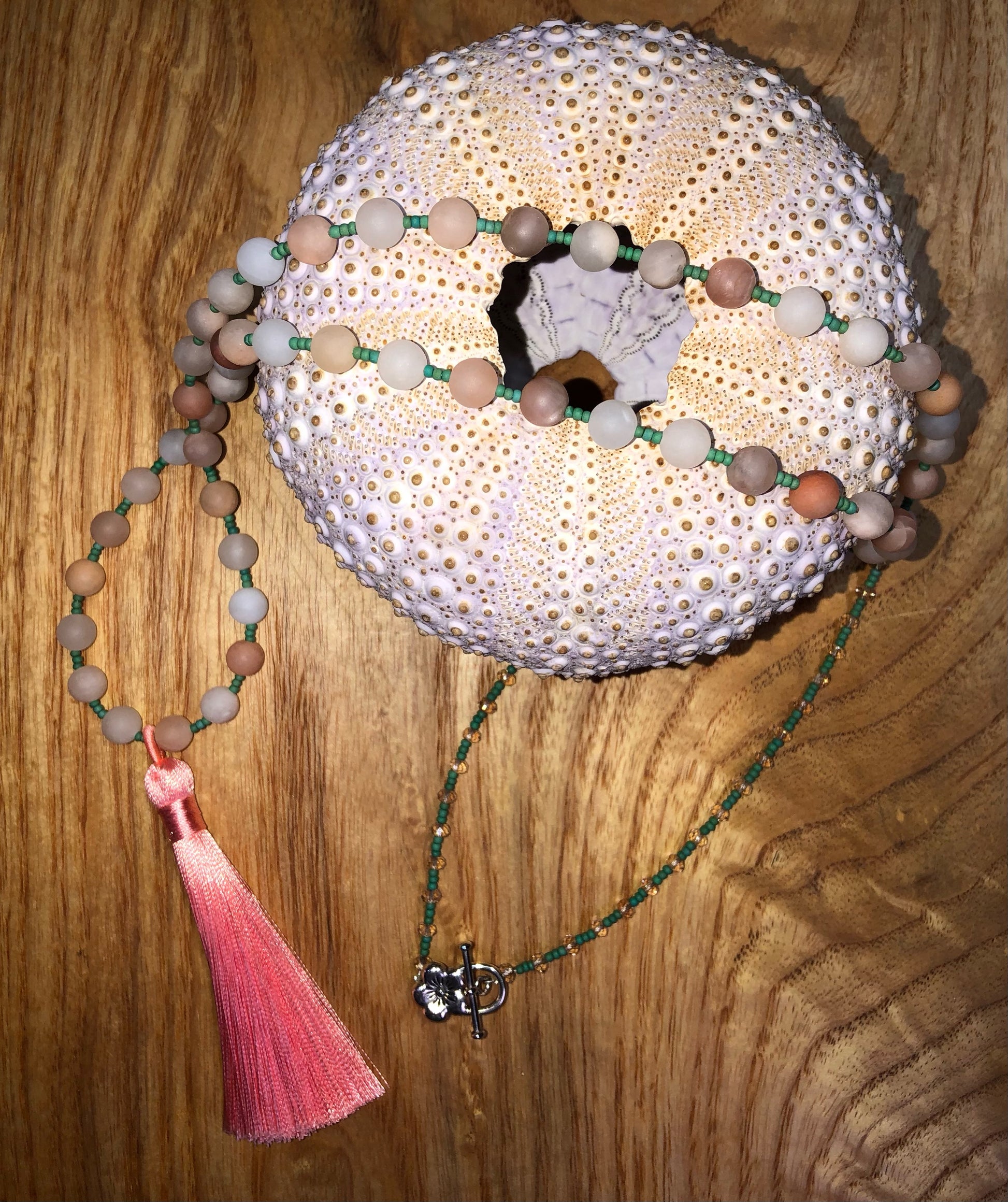 Mala with 54 matte peach aventurine beads, Austrian light peach faceted crystal beads, green glass seed beads, and 3.54" peach tassel.