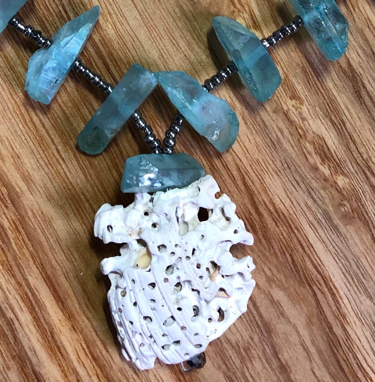 Aqua aura quartz points necklace with white coral, glass seed beads, & silver plated pearl clasp.