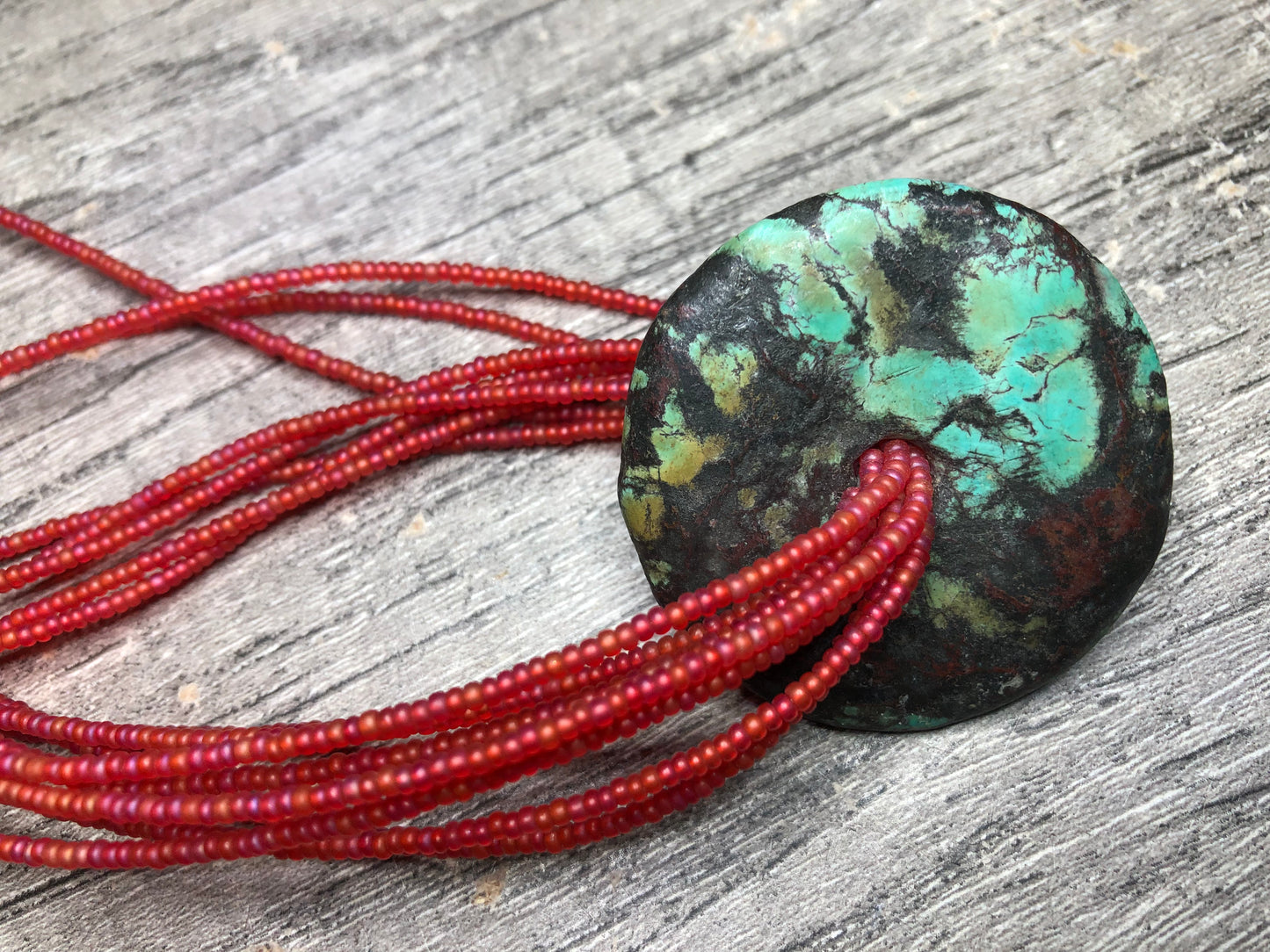 Turquoise Donut Pendant Strung on 8 Strands of Red Glass Seed Beads